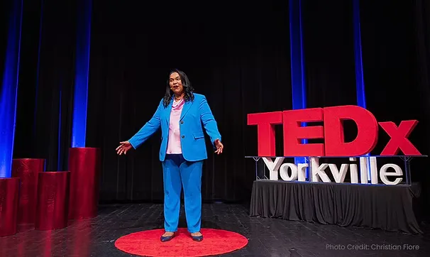 Bhuva Shakti giving a talk at TEDx Yorkville in front of a crowd